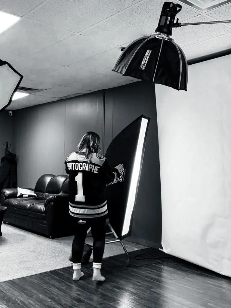 Athlete in jersey posing under studio lights during a professional sports-themed photo shoot.