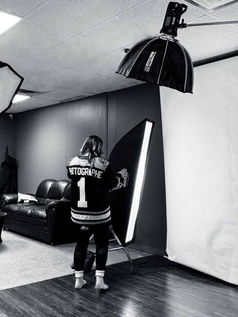 Athlete in jersey posing under studio lights during a professional sports-themed photo shoot.