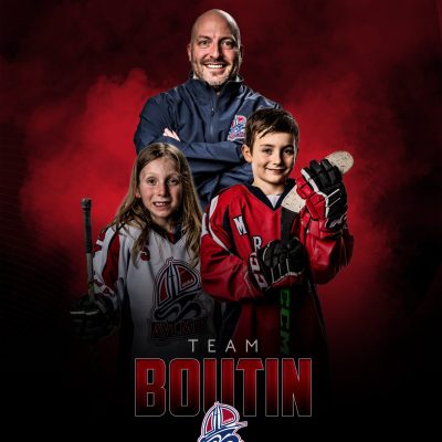 Youth hockey coach with two smiling players in red and white jerseys, Team Boutin portrait.